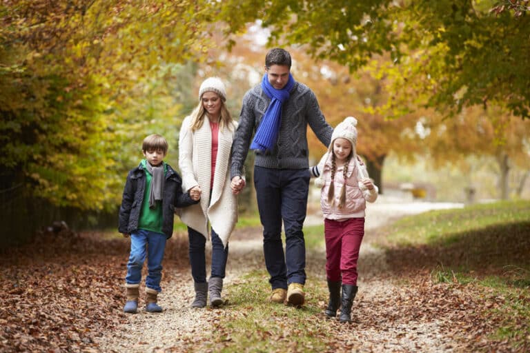 family walking along autumn path